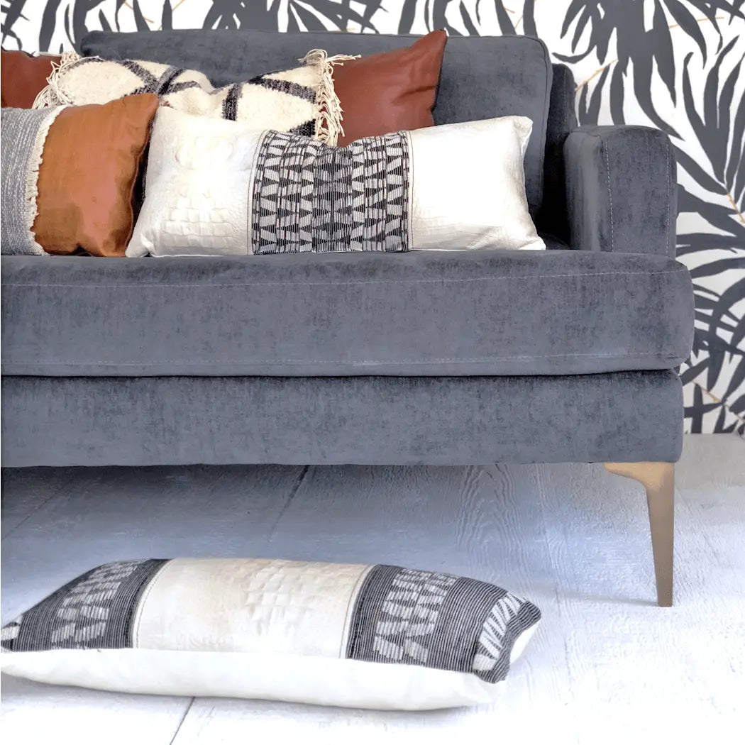 black and white leather decorative throw pillows on grey sofa