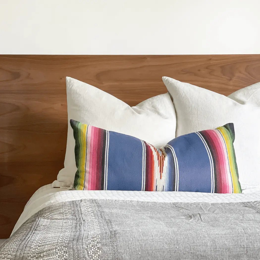 cobalt-blue-striped-vintage-pillow on queen bed