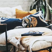 Navy and Gold Lumbar Pillow on white lounge chair with yellow pillow