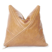 A tan leather throw pillow by Hunted Fox featuring a unique diagonal stitched design with contrasting white thread. The pillow has a soft, slightly distressed texture and a stylish, modern aesthetic, perfect for home decor.