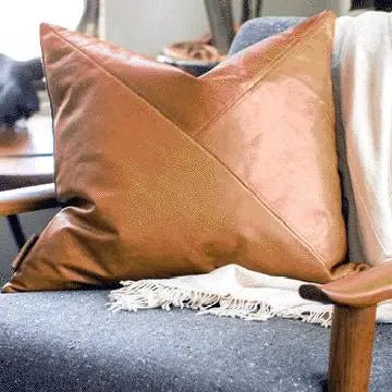leather decorative throw pillow sewn in three triangles with top stitching
