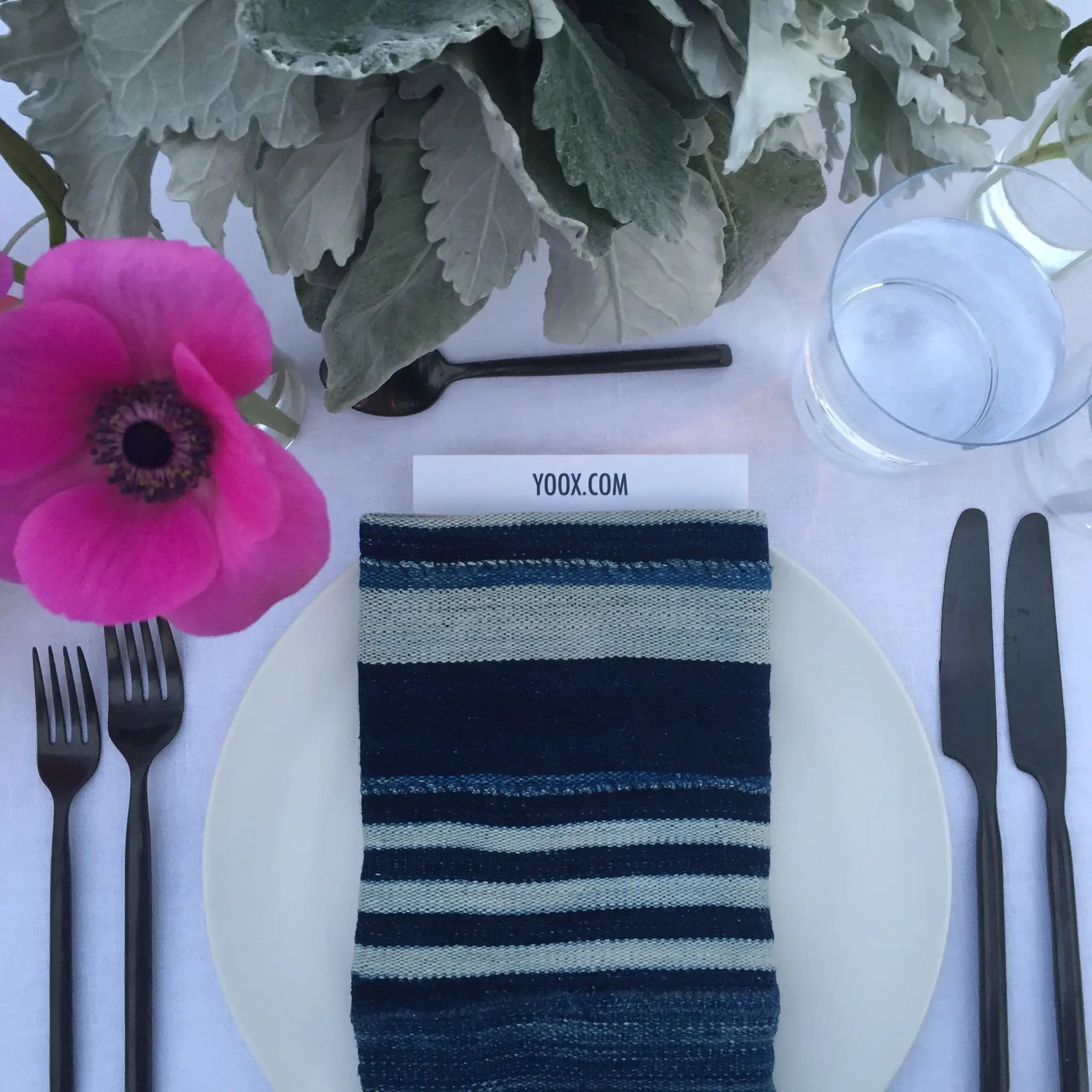 vintage African indigo custom folded napkin with a menu inside next to flowers