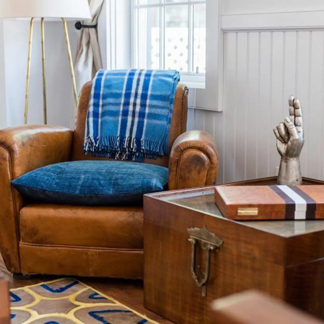 vintage leather chair with vintage African indigo pillows for seat cushions in a living room setting