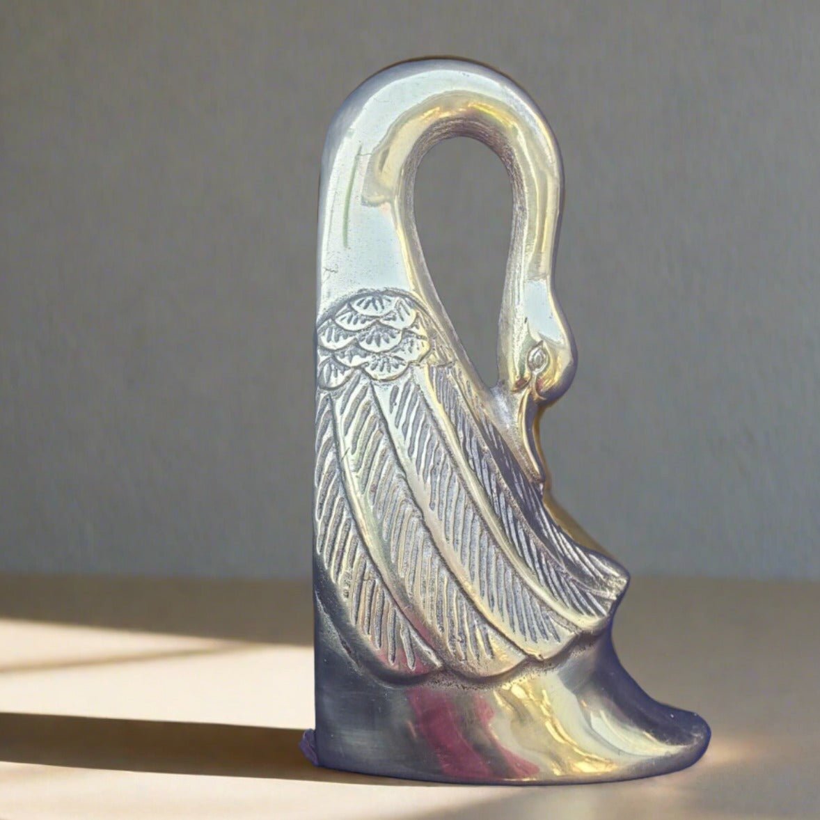 brass swan bookends coastal interior design