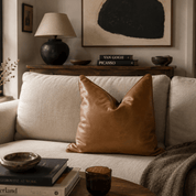 Brown Genuine Leather Pillow | Solid Leather - LEATHERLeather Pillowneed verificationHUNTEDFOX - Cozy living room with a beige sofa, brown pillow, and decorative items.
