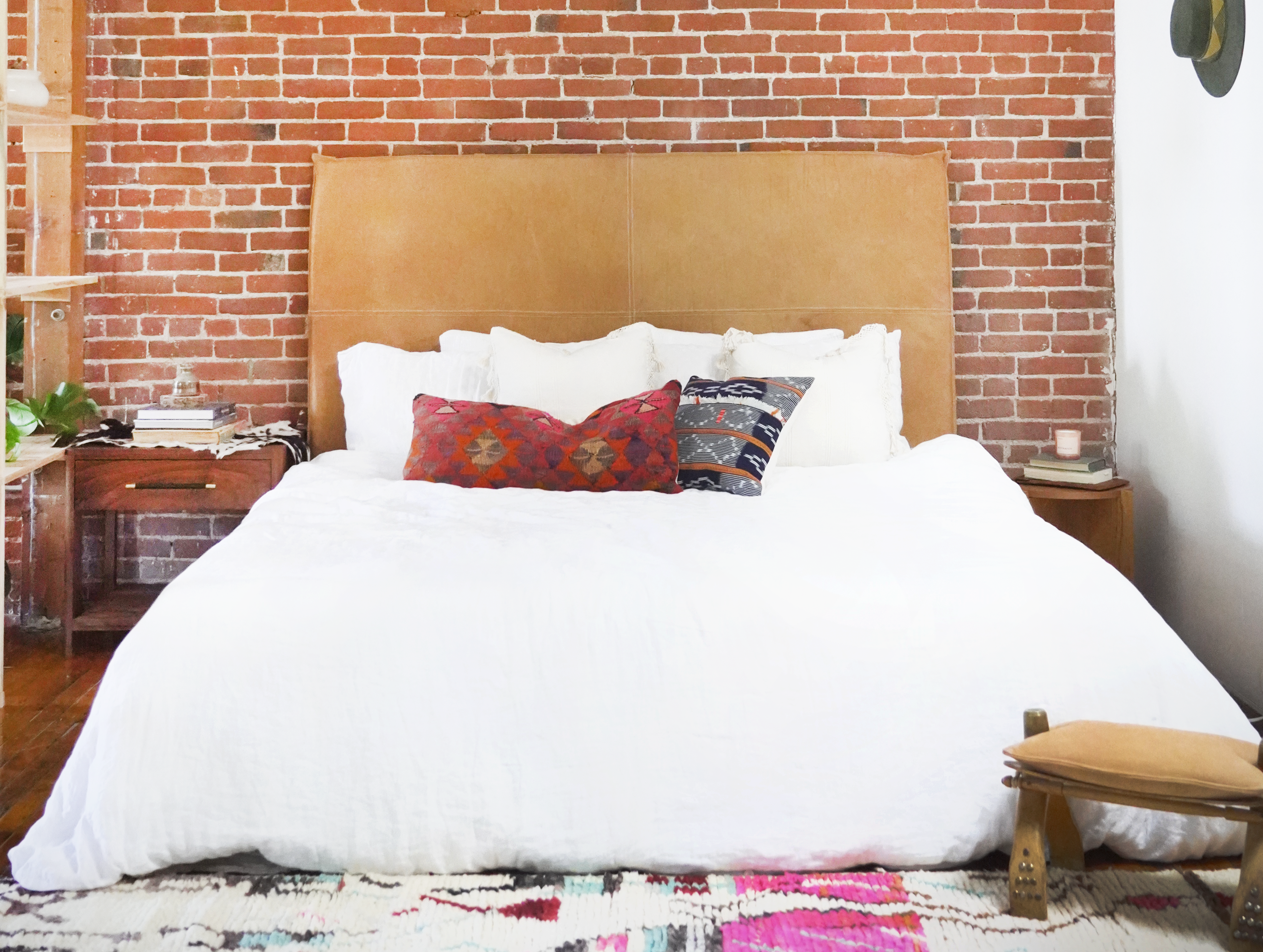 modern-loft-brick-building-bedroom-style-with-hanging-leatehr-headboard.png