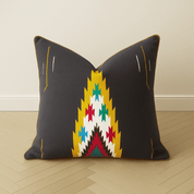Southwestern Navajo Accent Pillow - BAJA CHICBlackhunterHUNTEDFOX - Decorative pillow with geometric pattern on a wooden floor