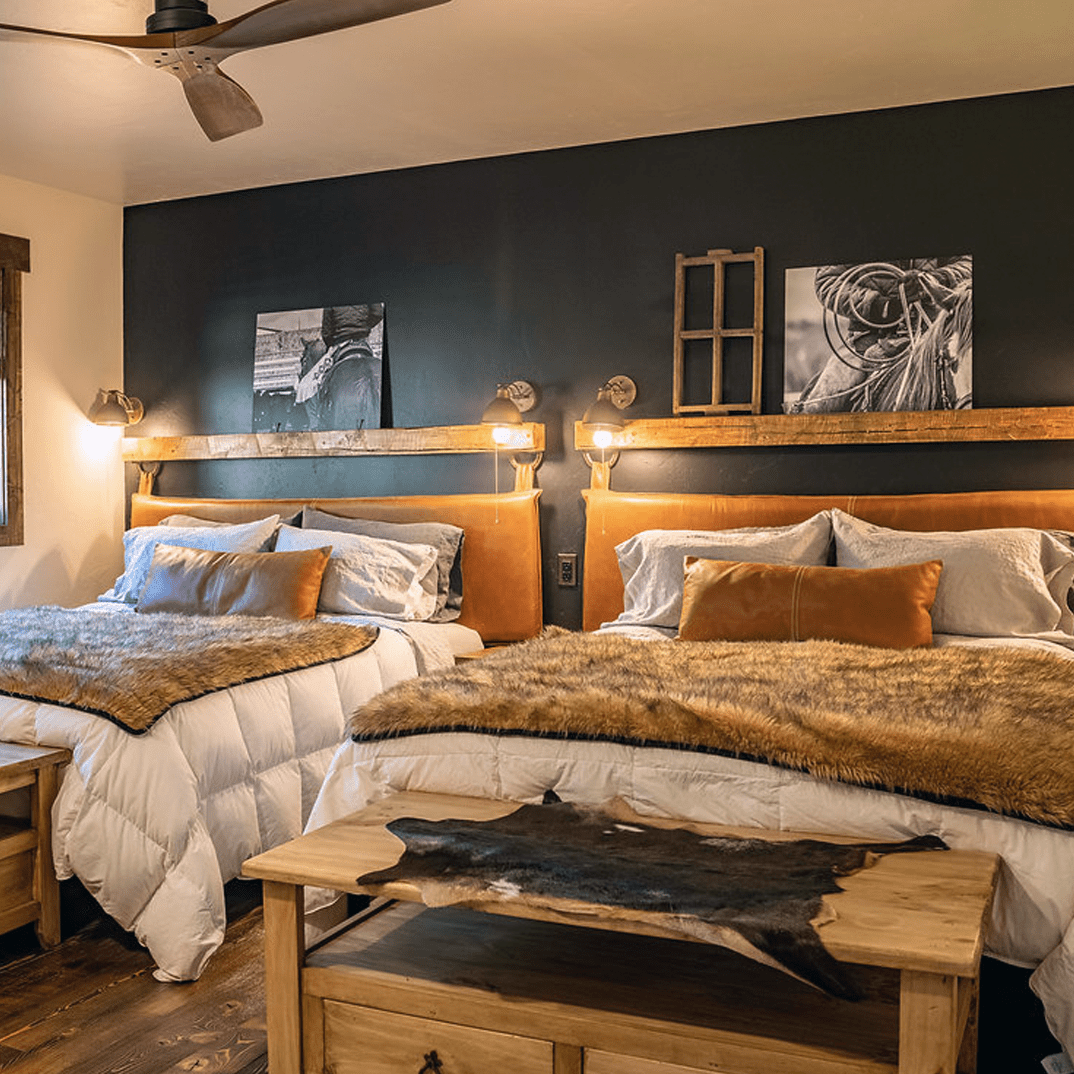 two queen beds in a rustic bedroom with leather headboards by HUNTEDFOX