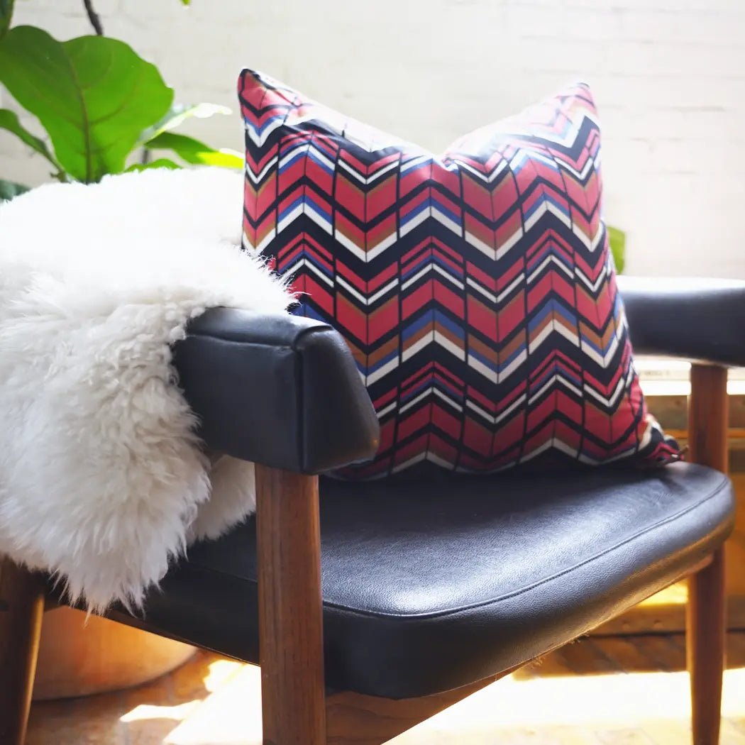 Red Black and White Chevron Pillow on Black Leather Chair