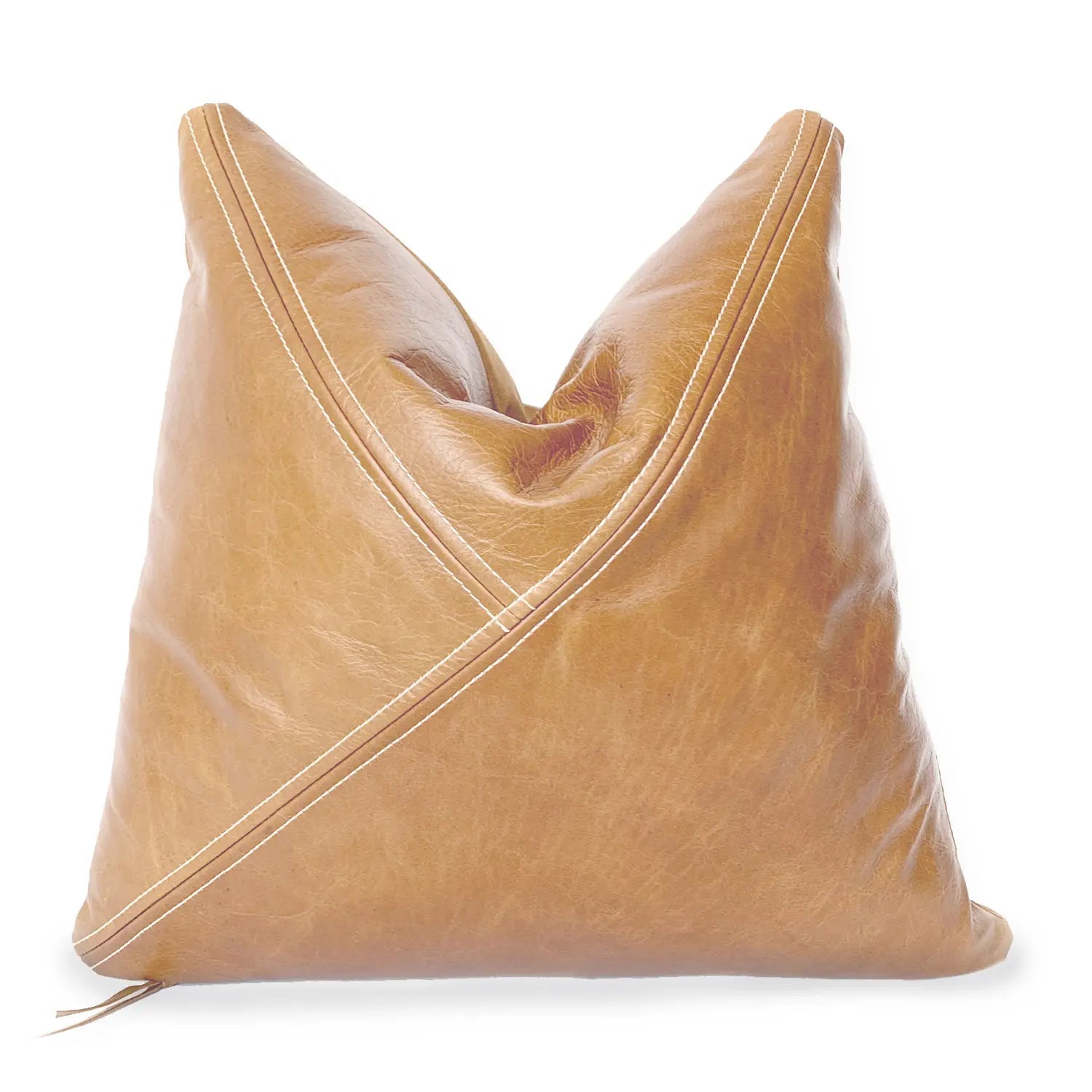 A tan leather throw pillow by Hunted Fox featuring a unique diagonal stitched design with contrasting white thread. The pillow has a soft, slightly distressed texture and a stylish, modern aesthetic, perfect for home decor.
